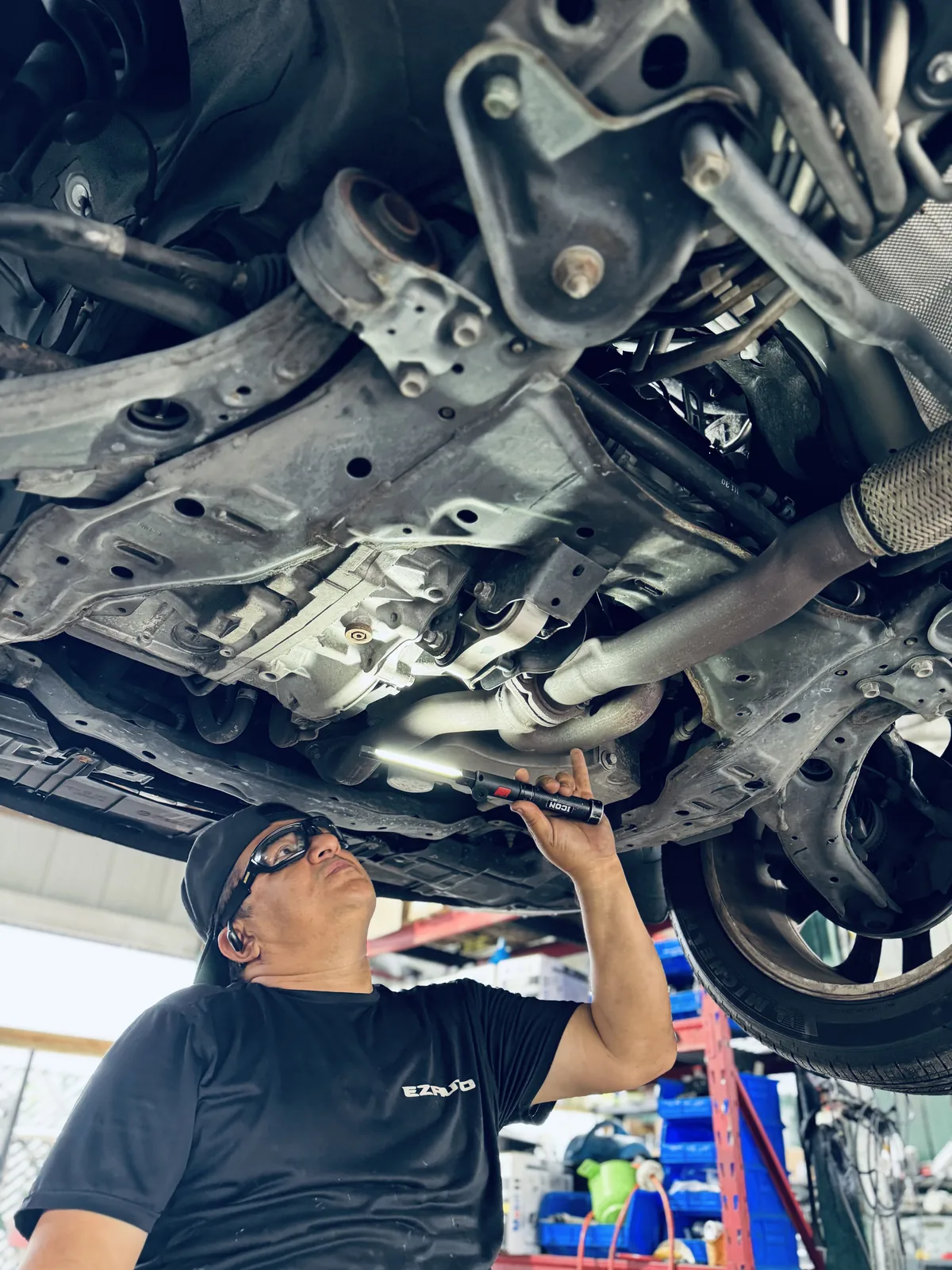 EZ AUTO Lakeland service bay — mechanic performing vehicle reconditioning